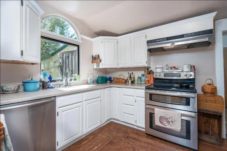 The kitchen features modern updates including solid surface counters